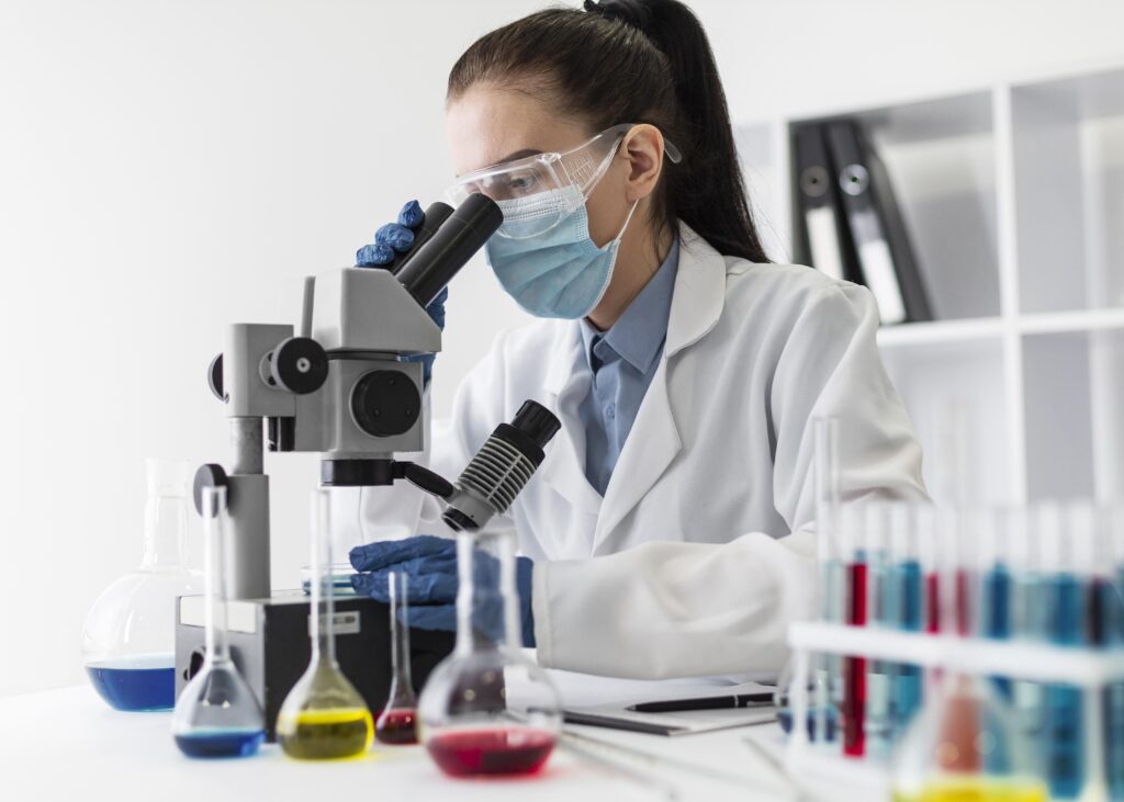 medium shot woman looking through microscope